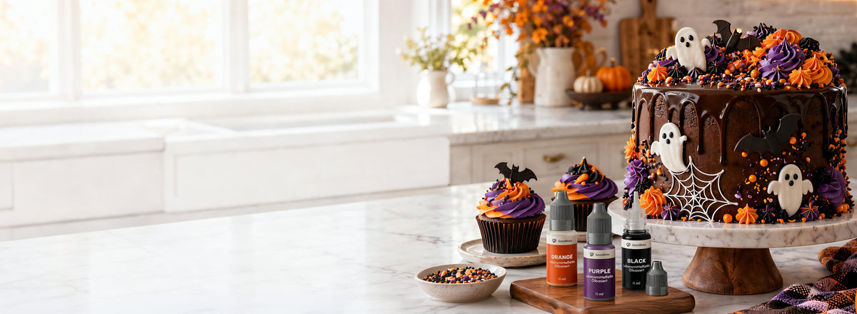 Halloween-Torte mit Schokoladen-Drip, Geistern und Fledermäusen, Cupcakes in Orange und Lila, davor ölbasierte Lebensmittelfarben in Orange, Lila und Schwarz